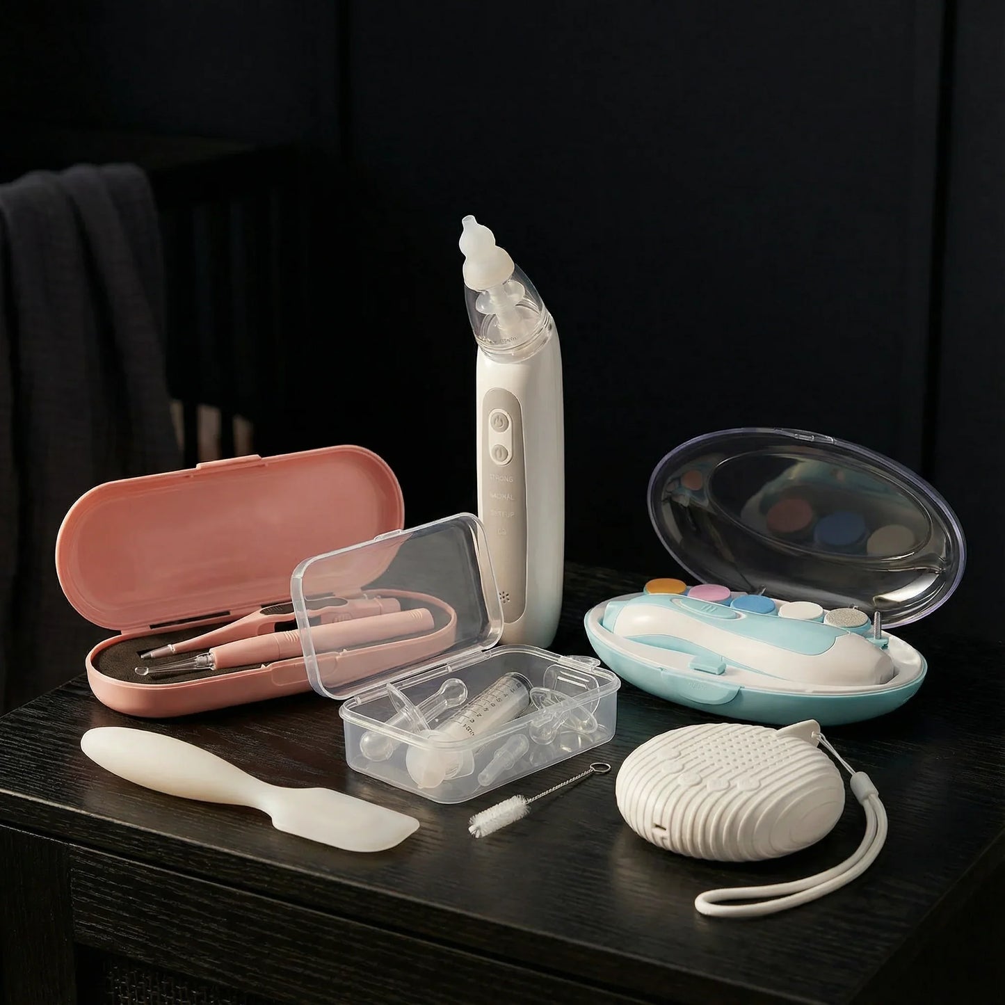 ORIGIN baby care grooming kit with electric nail trimmer, nasal aspirator, and accessories on table